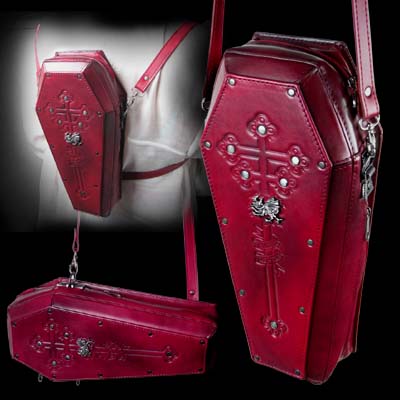 A stunningly hand-crafted masterpiece of alternative-elegance. Vlad Dracul's resting place, in sumptuous, antiqued burgundy red leather debossed with an Orthodox cross surmounted by a pewter Order of the Dragon crest. The bag is internally divided with two zipped compartments, opening one from the top and the other from the side. The adjustable strap can be moved to orient the bag vertically or horizontally, or for use as a back-pack; Approx. dimensions: 15.5cm (6") wide X 33cm (13") high X 8cm (3") deep. 